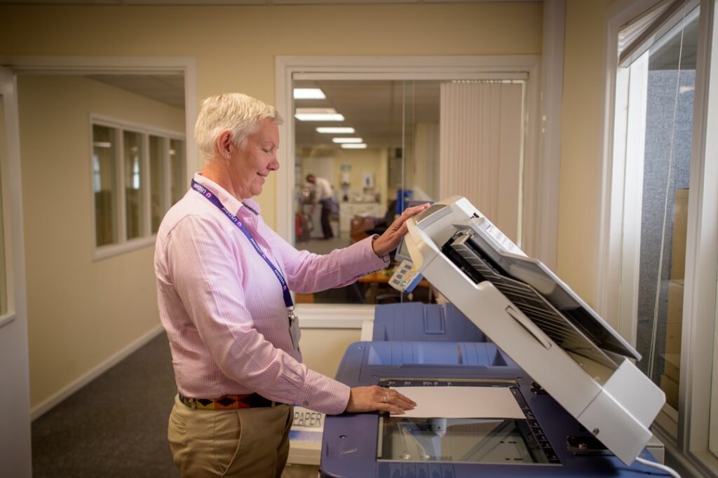 Hands placing document into scanner