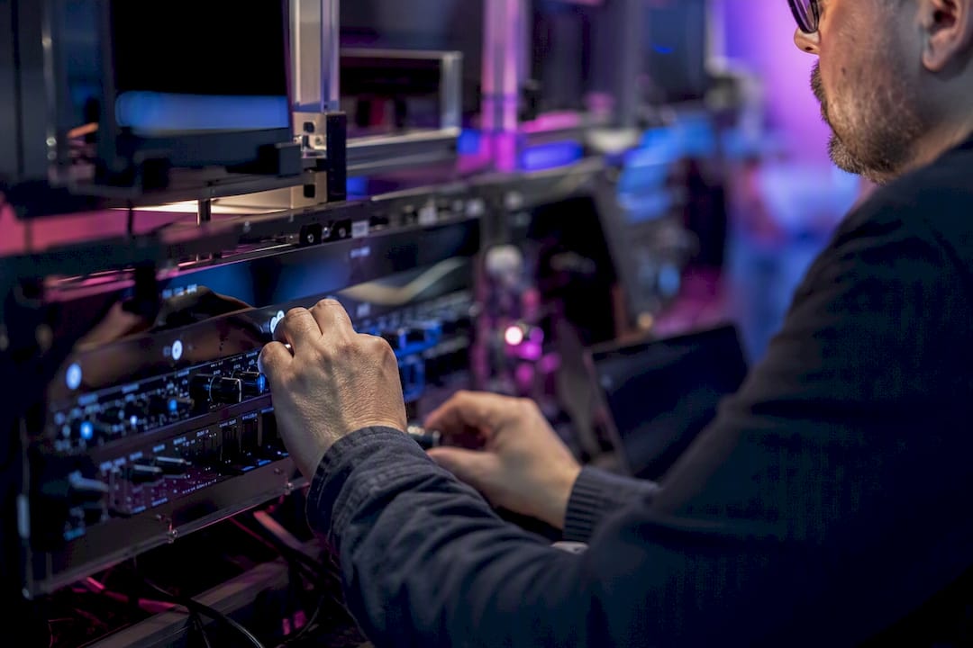 Hands tuning data monitoring controls close-up